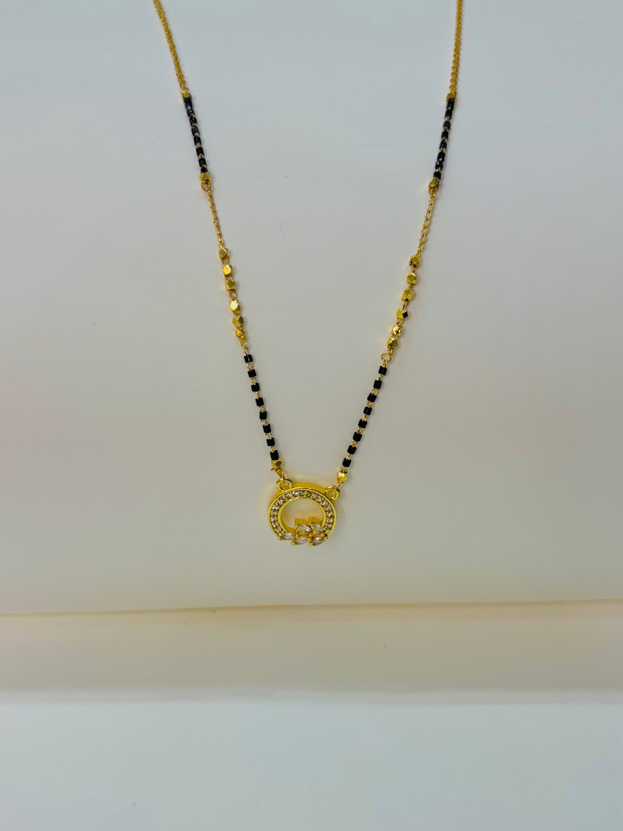 The round Crystal Demifine Mangalsutra i